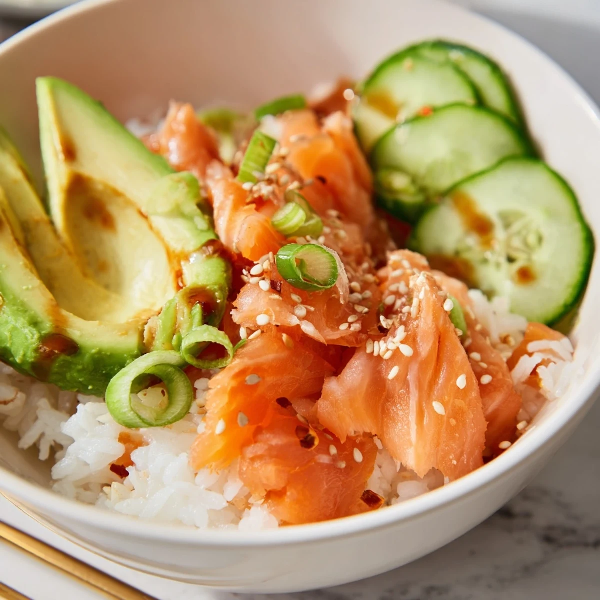 Delicious leftover salmon and rice bowl topped with fresh avocado and ginger.