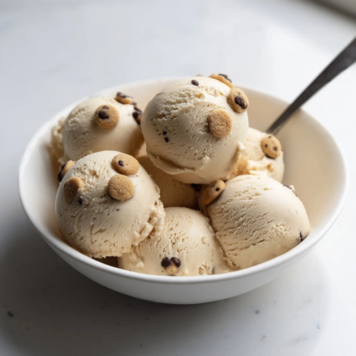 Creamy cottage cheese ice cream swirled with cookie dough bites, a delightful treat.  