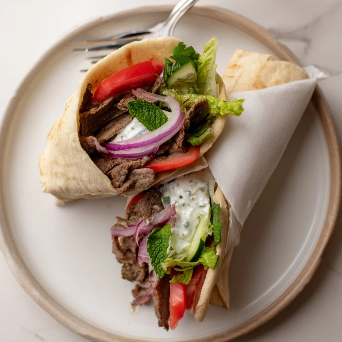 Tender beef shawarma wraps, filled with fresh veggies and creamy yogurt sauce.  