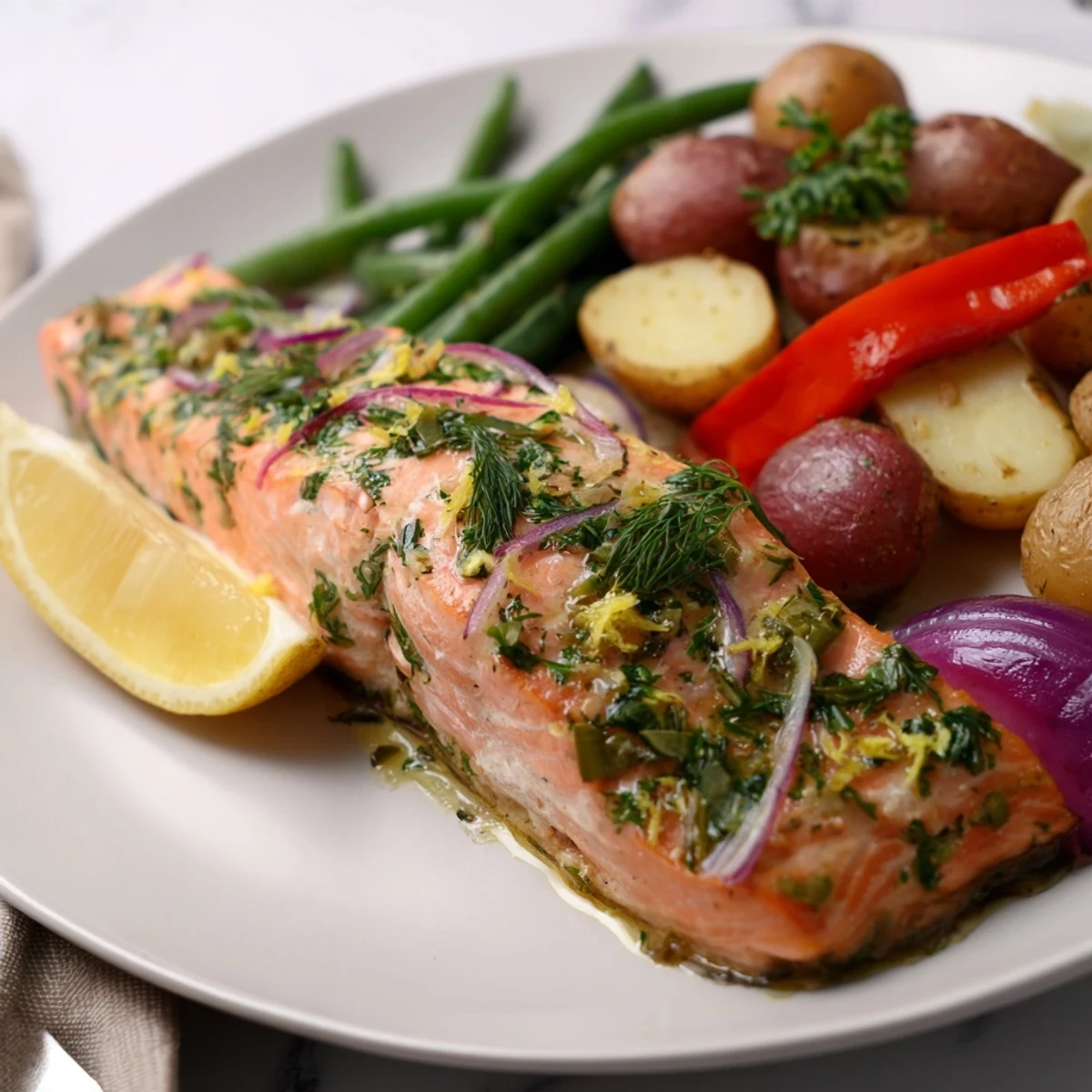 Crispy roasted potatoes accompany flavorful Lemon Herb Salmon & bright green beans.  