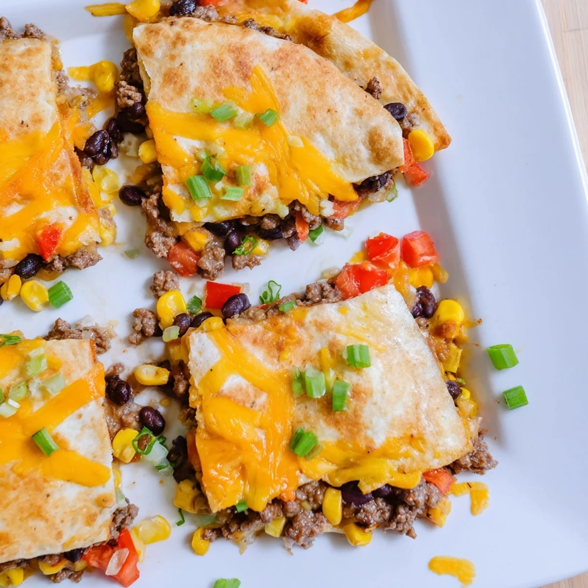 These hearty sheet pan quesadillas, overflowing with flavorful beef, are ready to be sliced and served.
