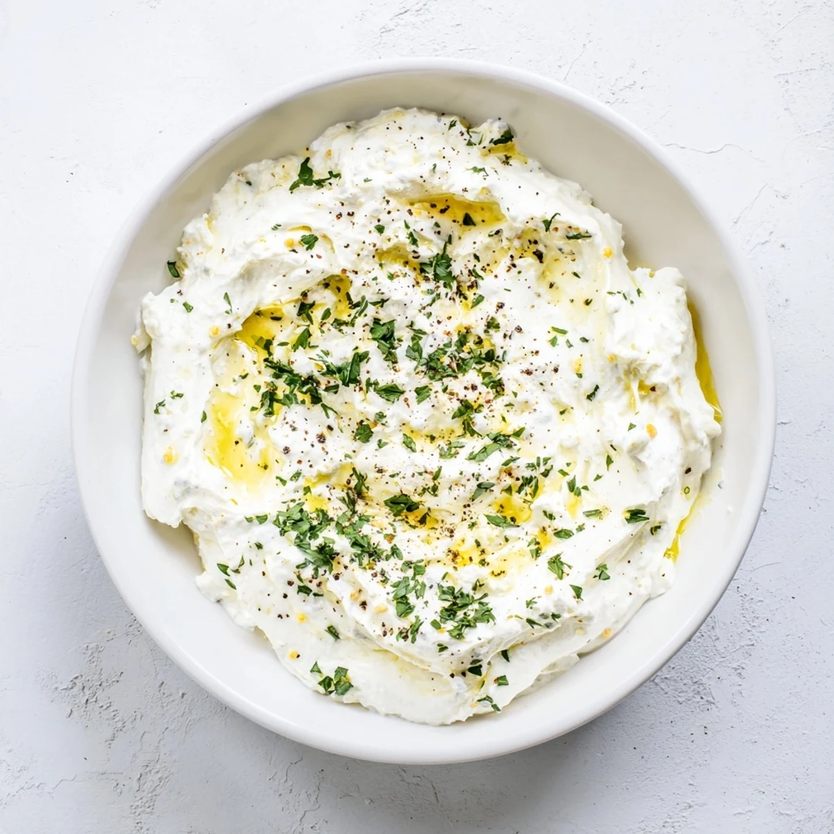 A close-up shot of the flavorful whipped feta recipe, beautifully garnished and ready to serve.