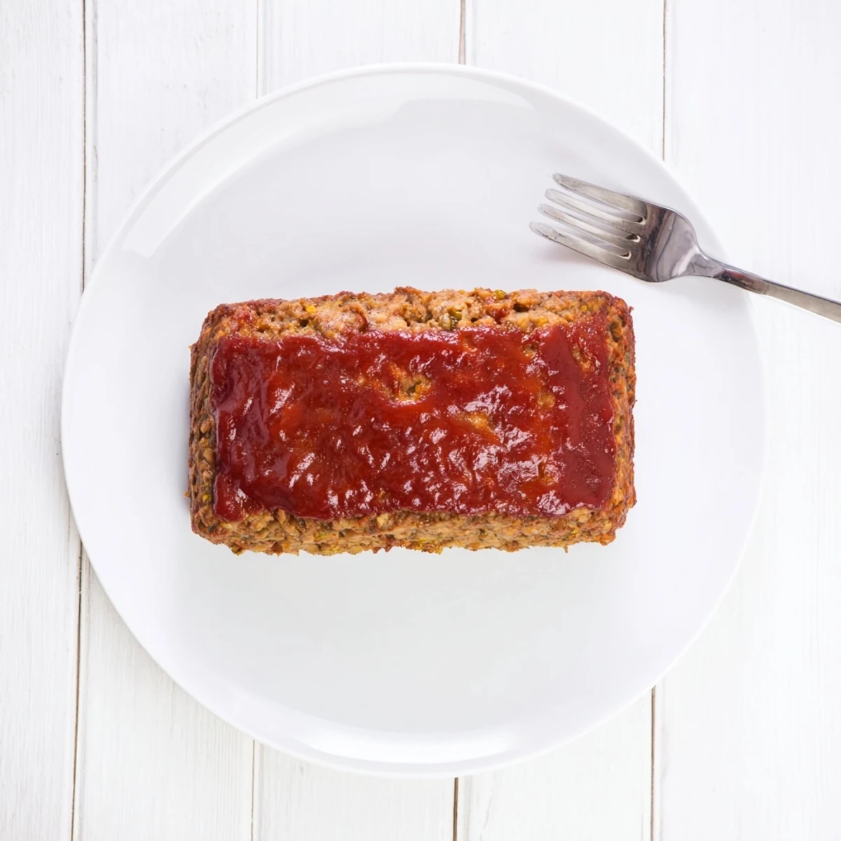 A close-up of a juicy Effortless Stove Top Stuffing Meatloaf Hack, ready and plated for serving.