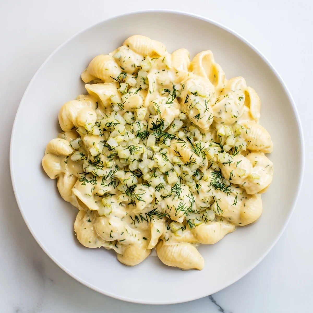 Golden, bubbly baked Pickle Mac and Cheese, with visible dill pickle bits and creamy cheese.