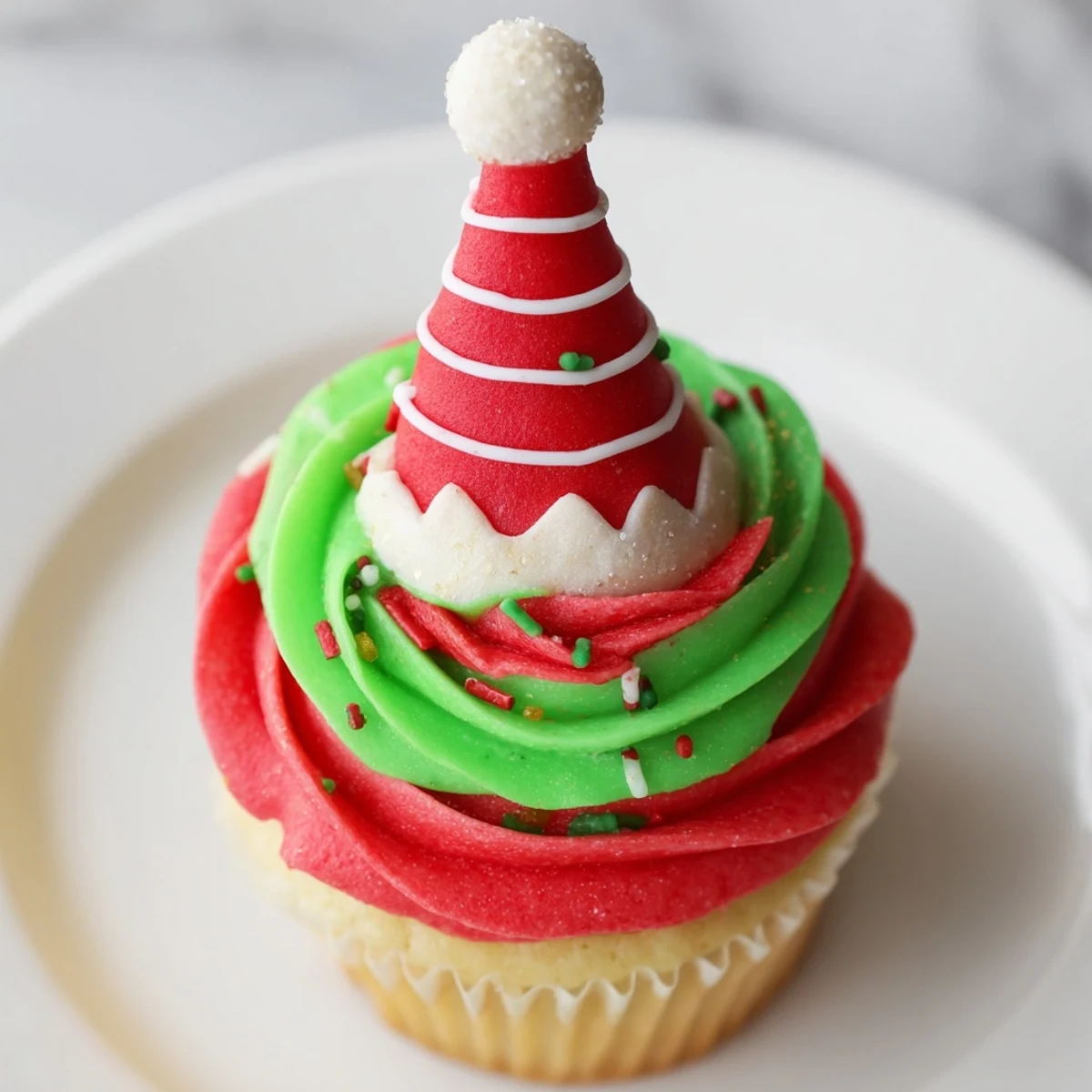 These sweet and colorful Elf Hat Cupcakes feature detailed fondant hats atop perfectly baked treats.