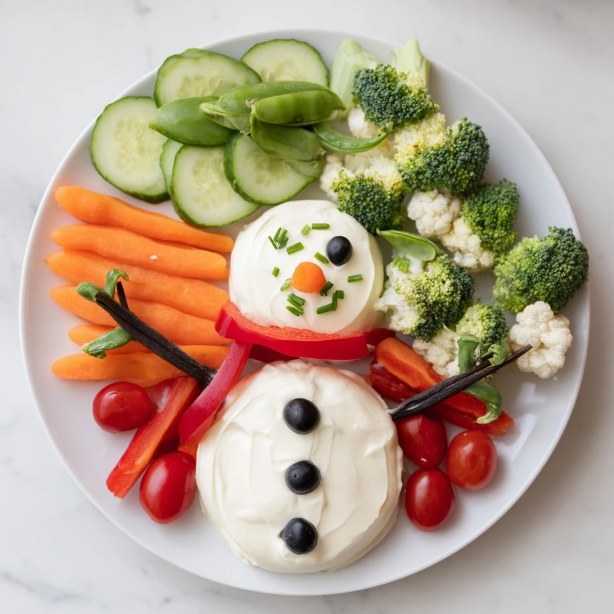 Snowman Veggie Dip Platter festively arranged with colorful veggies and creamy snowman dip ready to serve.