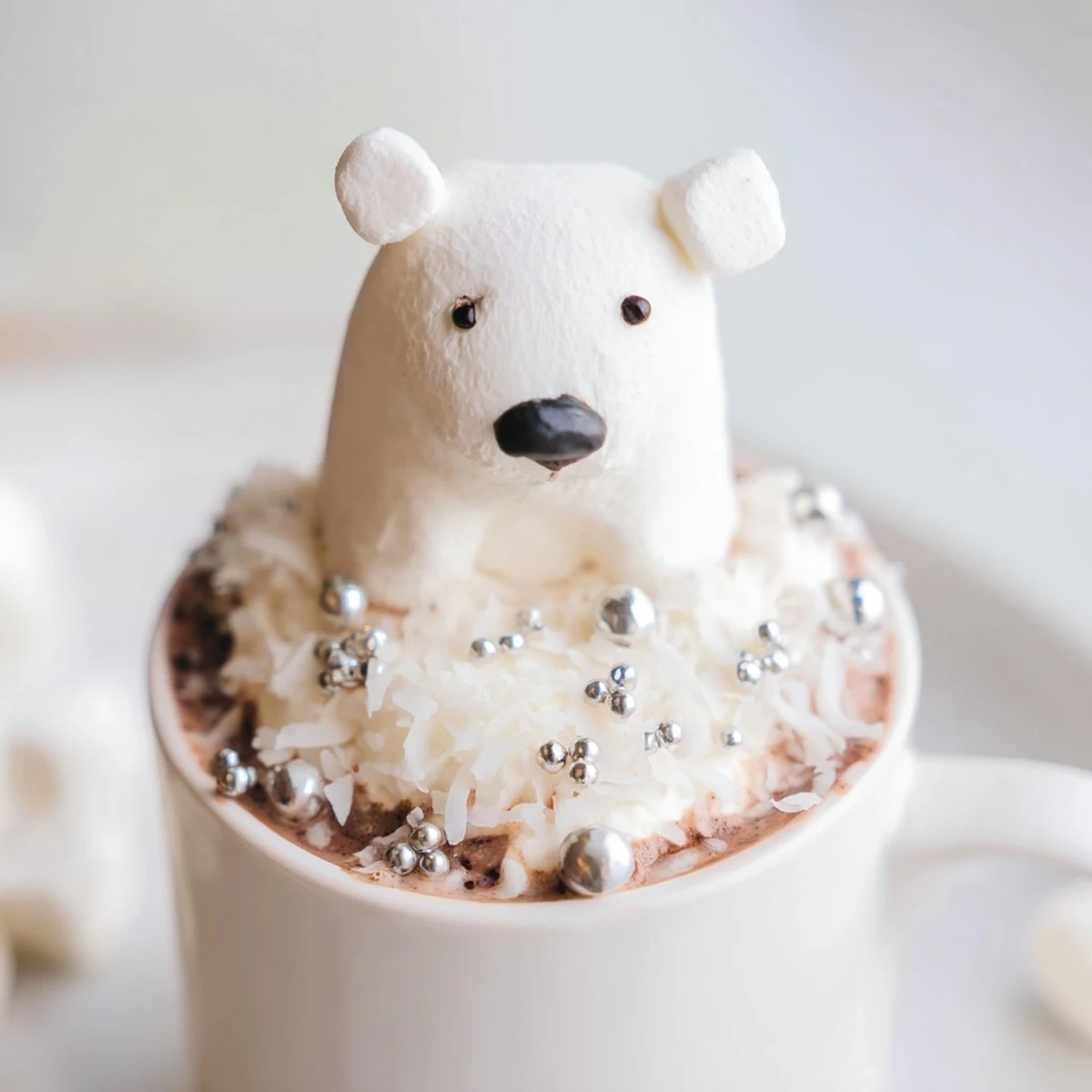 A festive platter of Polar Bear Hot Chocolate, garnished with whipped cream and snowy coconut flakes.
