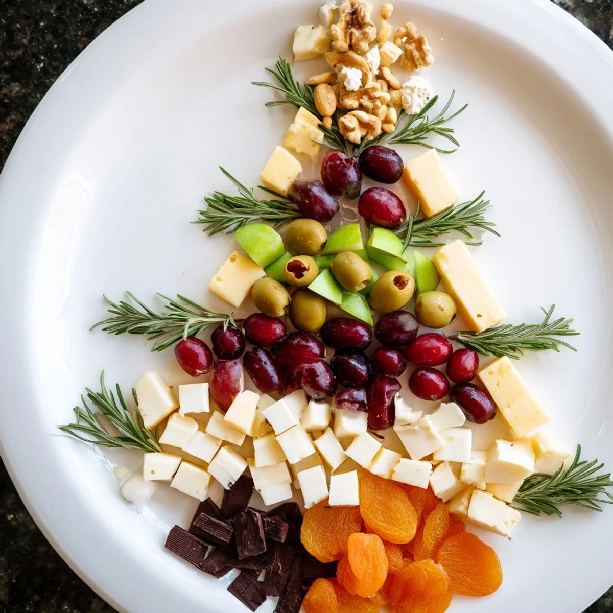 A beautifully arranged Cranberry Joy Tree Board loaded with cheese, fruit, and rosemary sprigs for a holiday treat.