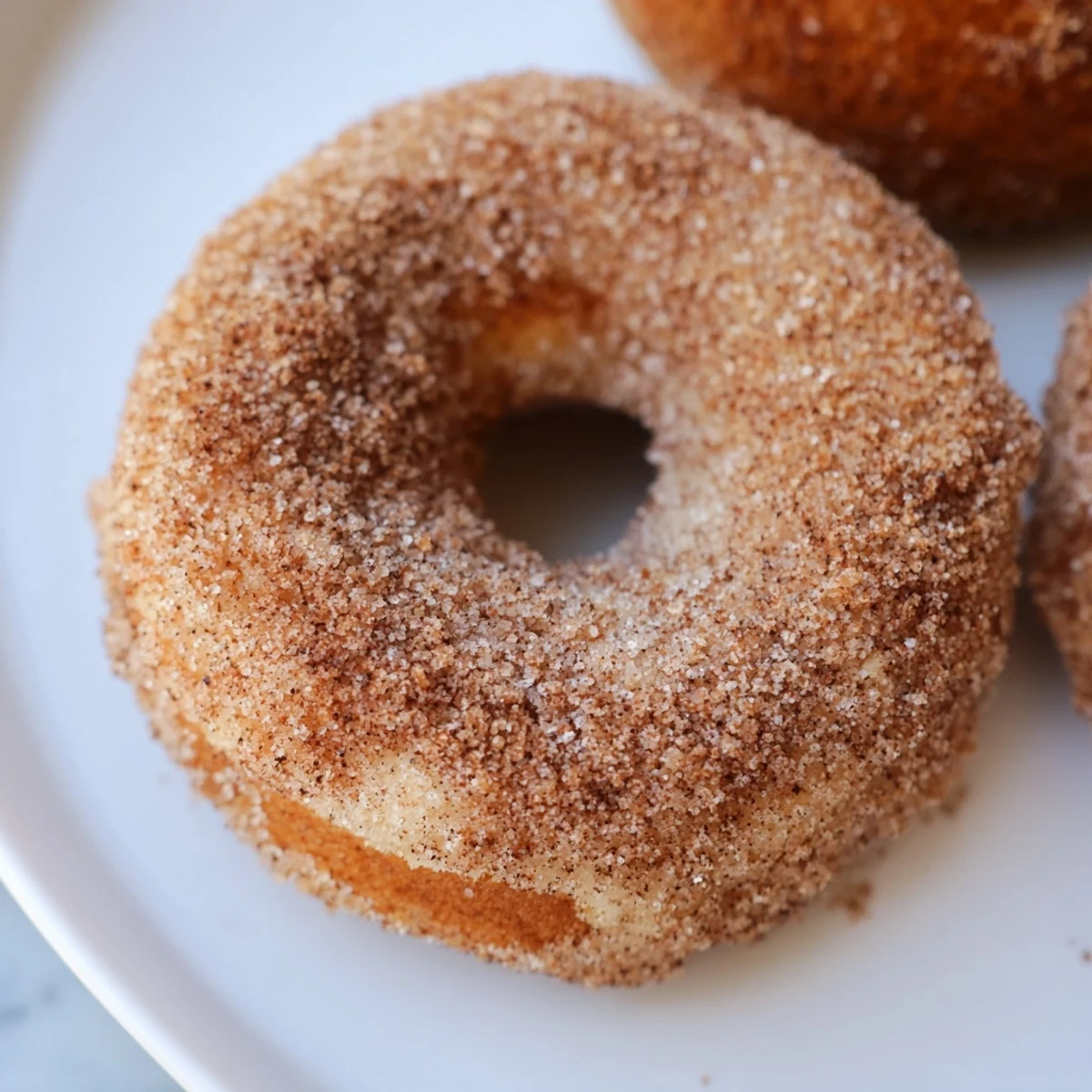 Warm, freshly baked donuts coated with sweet cinnamon sugar, an easy recipe to follow.