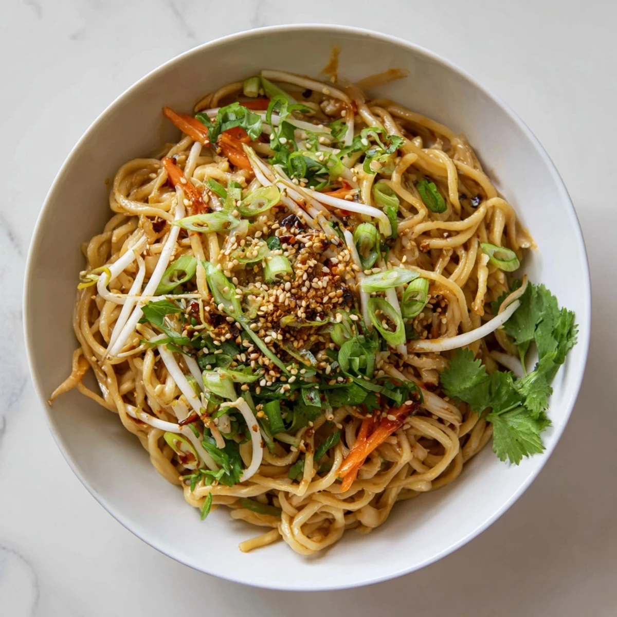 Quick and savory Asian Garlic Noodle Bowl served with optional chili slices and cilantro.