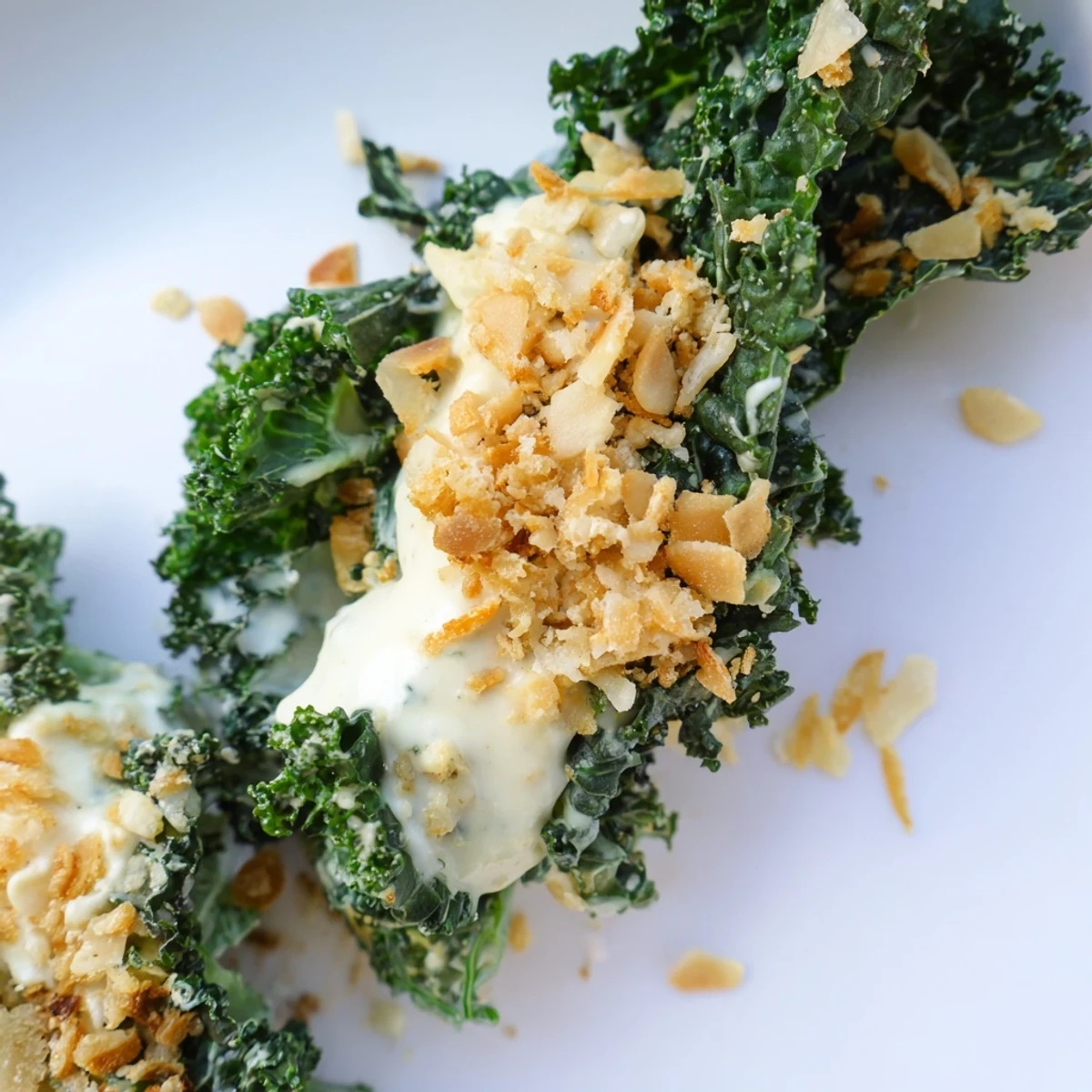 Freshly massaged kale for this Garlic Parmesan Kale Salad paired with garlic dressing, pepper, and toasted crumbs for perfect texture.