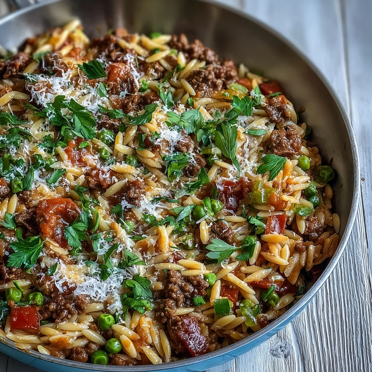 A hearty bowl of Comforting Ground Beef Orzo Dinner, featuring tender pasta, savory beef, and sweet bell peppers.
