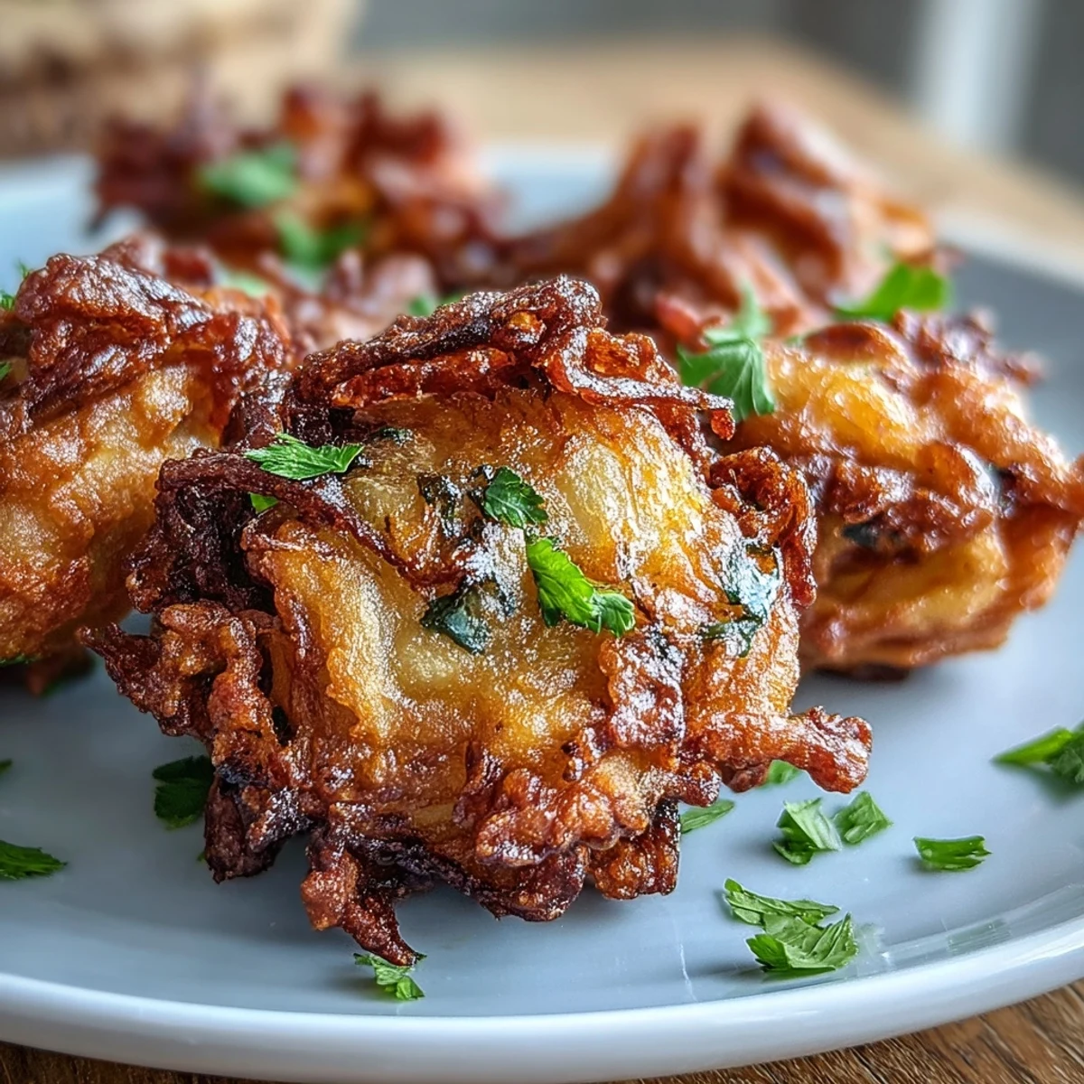 Golden crispy onion fritters seasoned with Indian spices, air-fried for a healthier take on classic street food.