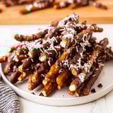 Enjoy a sweet and salty treat: perfectly arranged chocolate covered pretzel sticks, ready to eat.