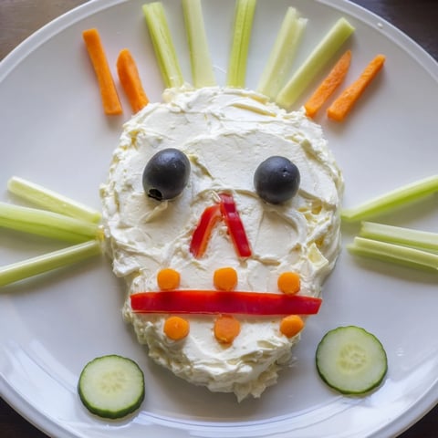 A Halloween Skull & Bones Spooky Spread, artfully arranged creamy spread with vegetable features, ready to serve.