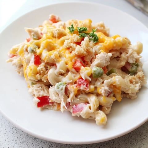 Creamy, golden Chicken Macaroni Southern Style casserole bubbling in a baking dish, ready to serve and enjoy.