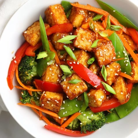 Golden, crispy Sesame Ginger Tofu Stir-Fry with bright vegetables and glistening sauce.