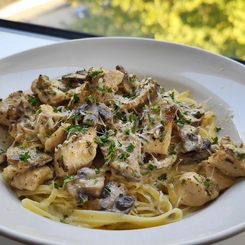 Creamy Mushroom Chicken Pasta: A close-up of a bowl filled with rich, creamy pasta and chicken.