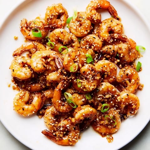 Golden brown Honey Garlic Shrimp glistening, ready to serve with fluffy white rice for dinner.
