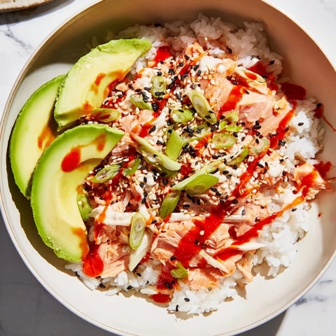 Steaming bowl of Classic Salmon Rice with creamy avocado slices, ready to enjoy.