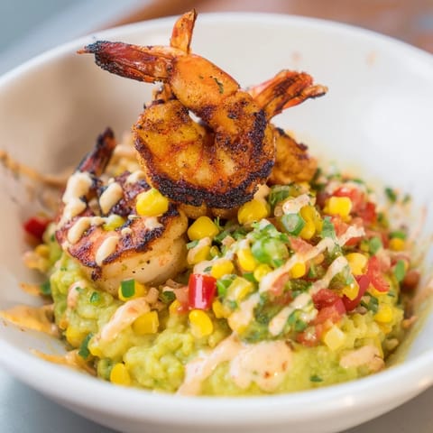 Colorful Grilled Shrimp Bowl featuring creamy avocado and zesty corn salsa, ready to enjoy.  