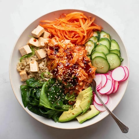 Vibrant Fermented Vegetable Bowl topped with sesame seeds and spicy chili flakes.  