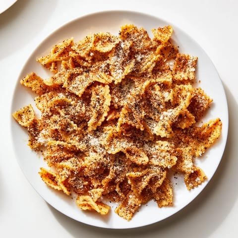 Golden brown Pasta Chips Seasoned Variety, perfect for dipping in creamy hummus.  