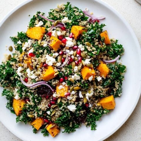 A colorful bowl of Kale & Quinoa Salad: the quinoa and sweet potato are perfectly seasoned.