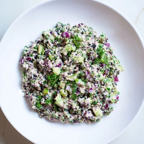 Vibrant chickpea tuna salad with visible diced vegetables and a creamy, plant-based dressing.