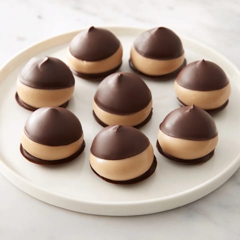 Rich, chocolate-covered Peanut Butter Buckeyes with visible peanut butter filling, a delicious homemade dessert option.