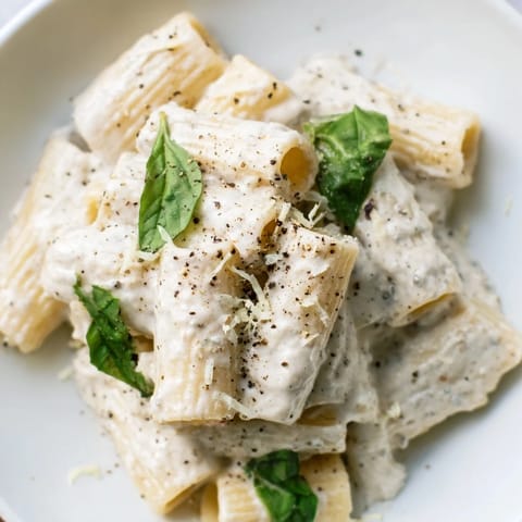 A bowl of delicious creamy cottage cheese pasta showcases the perfectly coated pasta and inviting texture.
