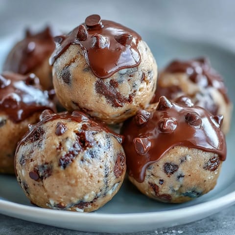 High-protein cookie dough bites with chocolate chips, rolled oats, and almond butter for a healthy, no-bake treat.