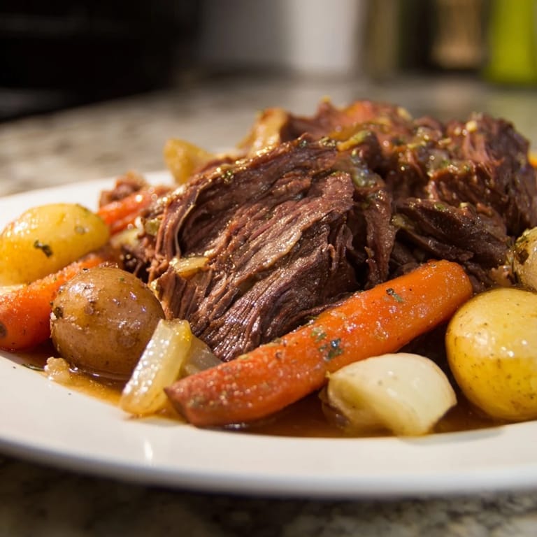Fork-tender Sunday Pot Roast, beautifully seared, surrounded by flavorful roasted carrots and potatoes.