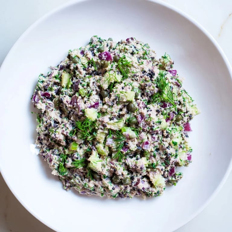 Vibrant chickpea tuna salad with visible diced vegetables and a creamy, plant-based dressing.