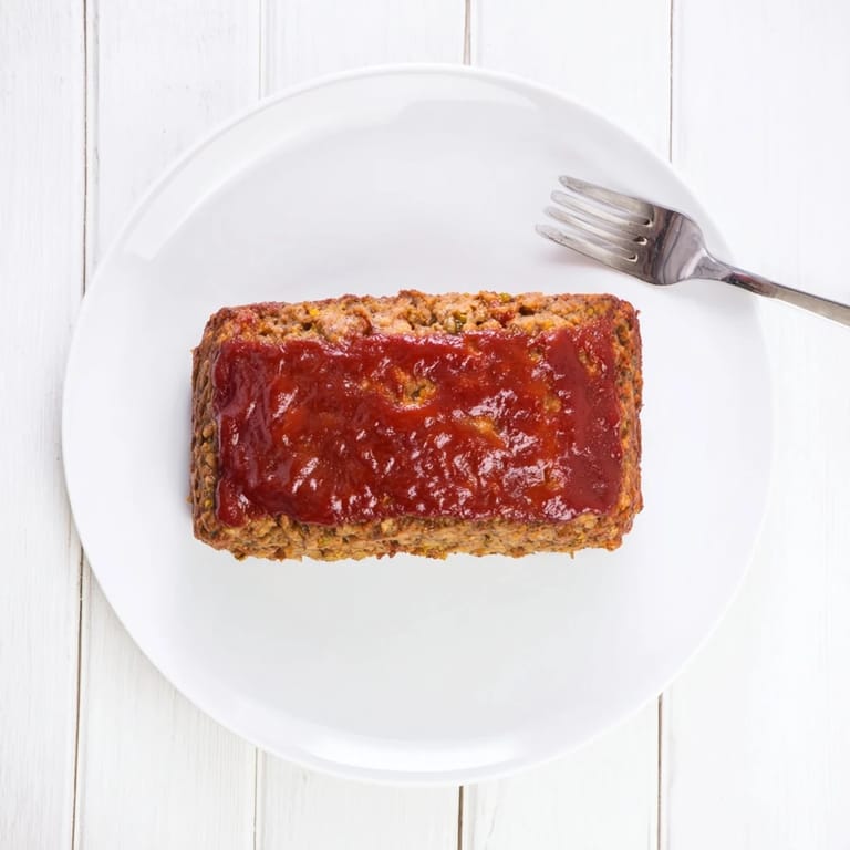 A close-up of a juicy Effortless Stove Top Stuffing Meatloaf Hack, ready and plated for serving.