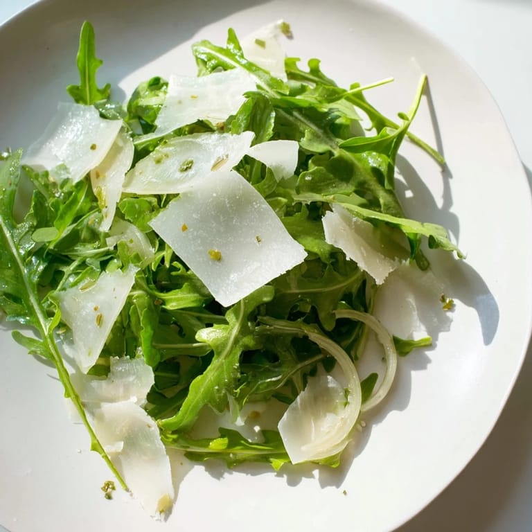 A beautiful close-up of arugula salad, a light Italian treat prepared with lemon and Parmesan.