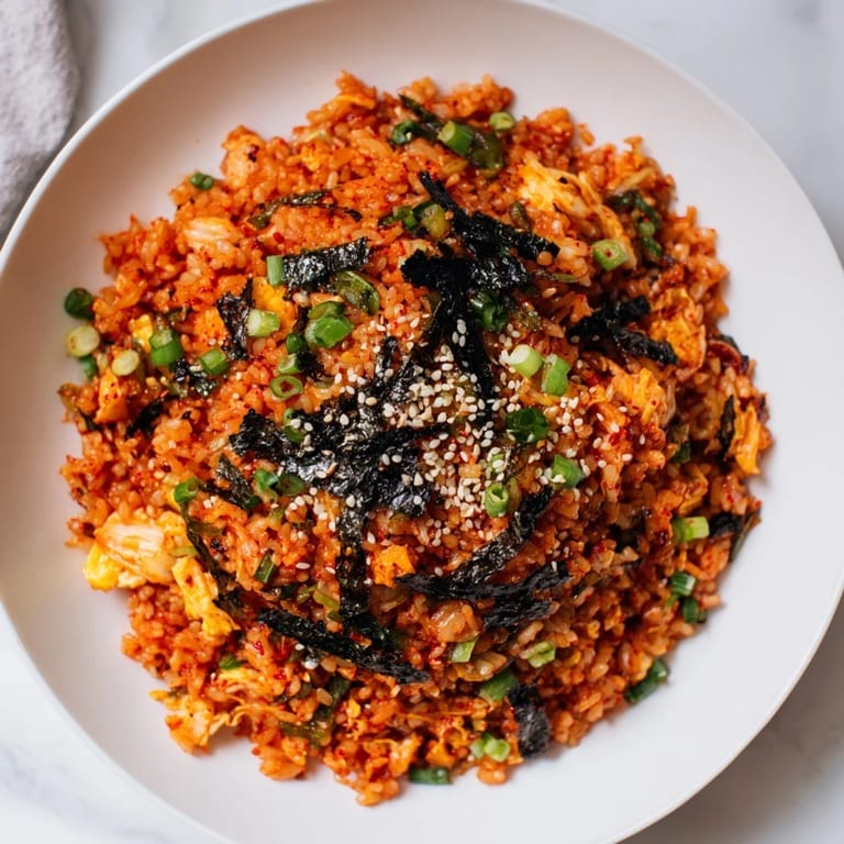 A close-up of colorful Spicy Kimchi Fried Rice featuring crisp vegetables and tender scrambled egg ribbons.