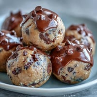 High-protein cookie dough bites with chocolate chips, rolled oats, and almond butter for a healthy, no-bake treat.