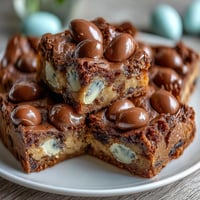 Cadbury Egg Blondies with White Chocolate Drizzle: chewy, candy-studded bars drizzled in creamy white chocolate, perfect for Easter or spring baking.